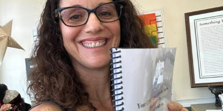 Miki holding draft of her book