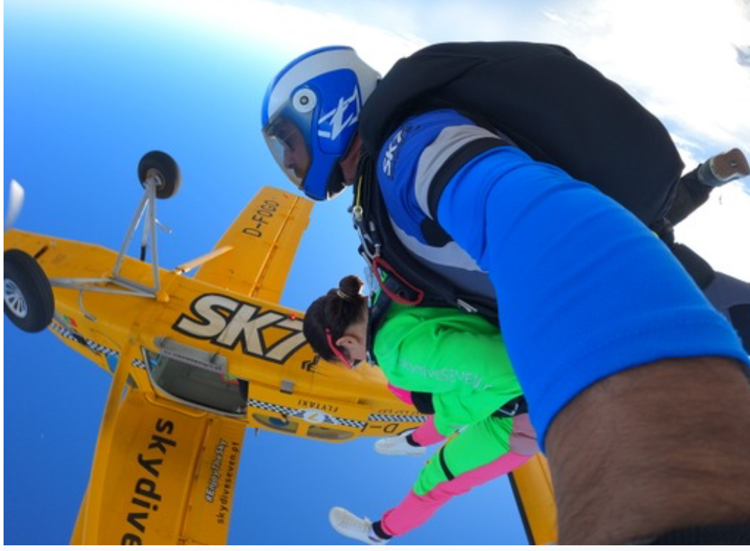 Miki skydiving with the plane above