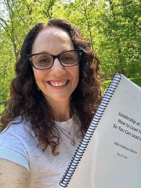 Miki with a draft copy of her book